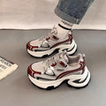 Women's red and silver clunky platform sneakers with mesh lining and rubber sole.