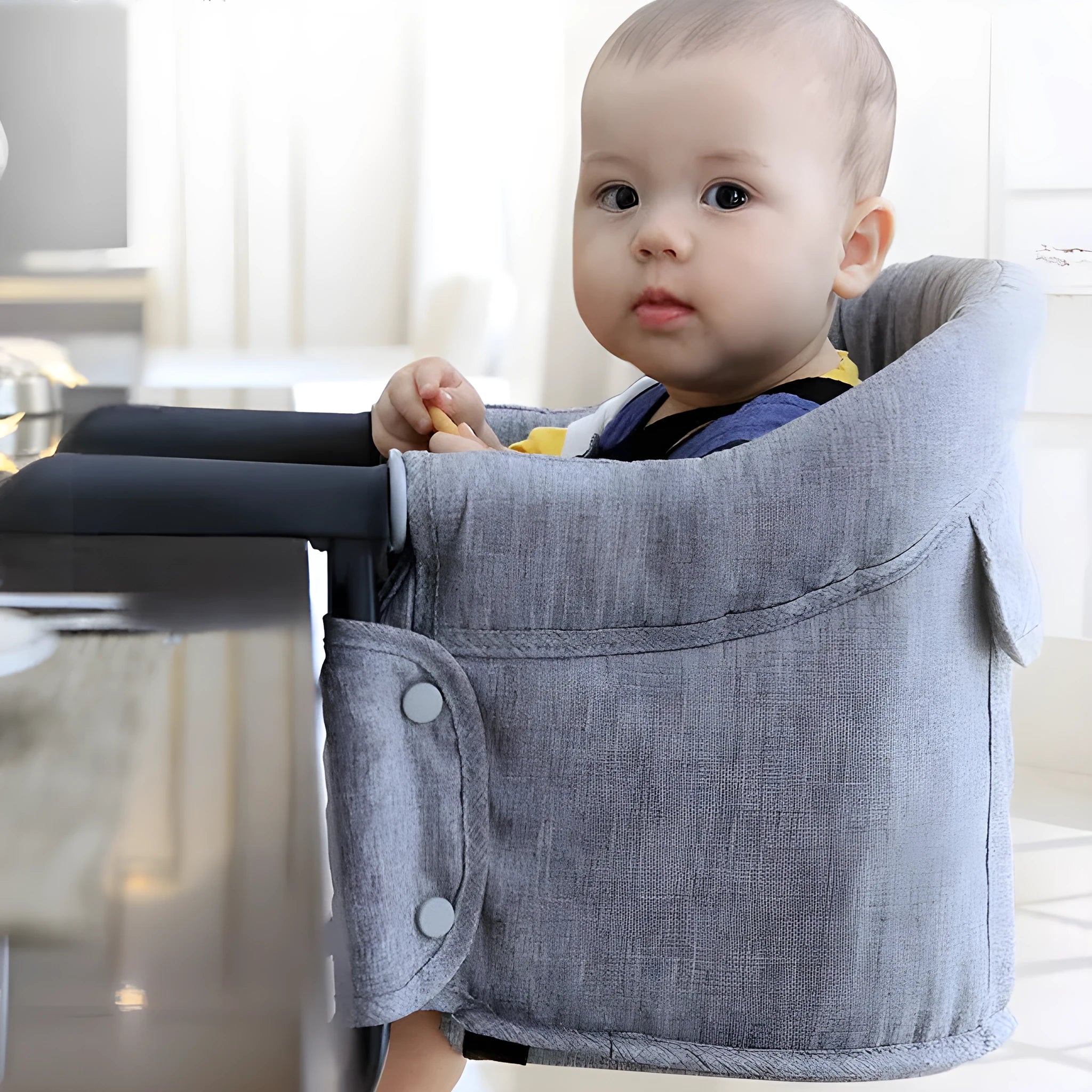 Portable baby dining seat with safety belt in blue, grey or red colours folded to show compact 42x36x7cm size