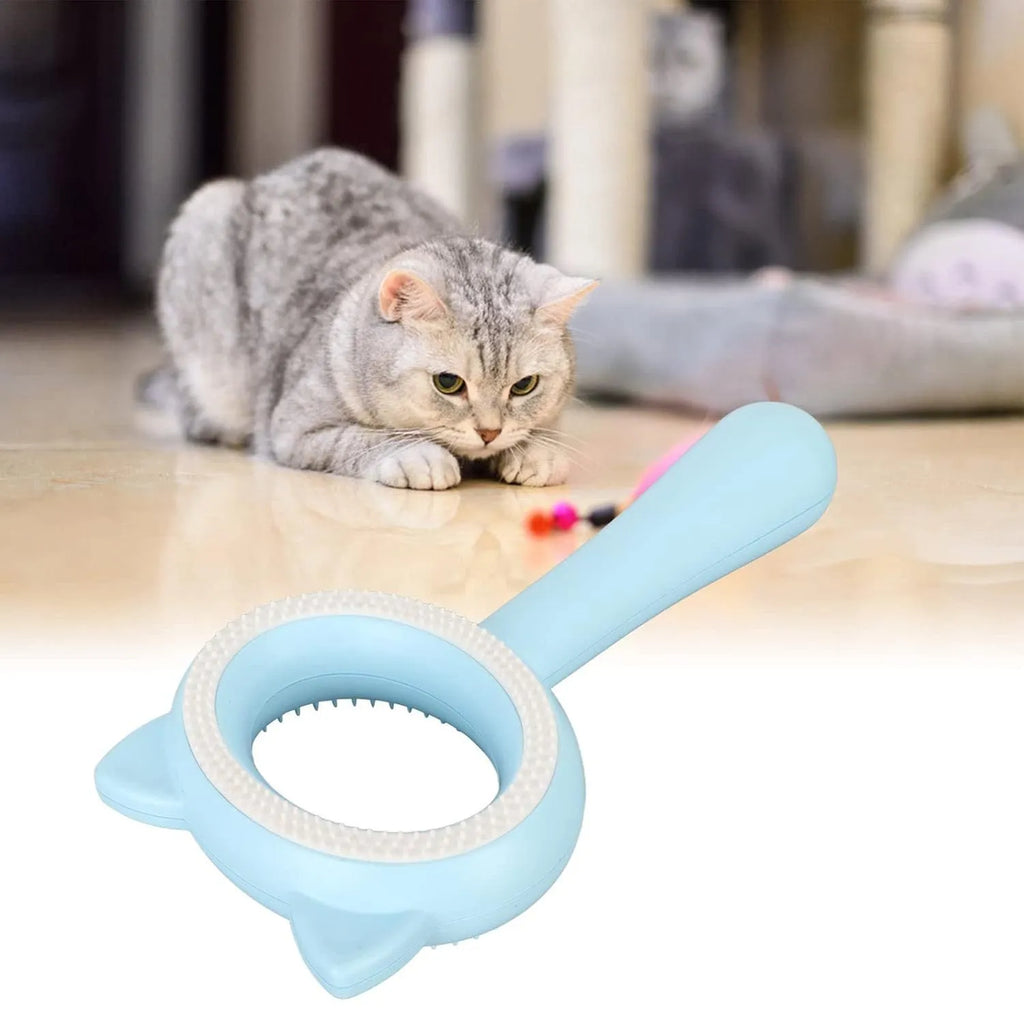 Blue and white double-sided pet grooming brush with ergonomic handle on a table