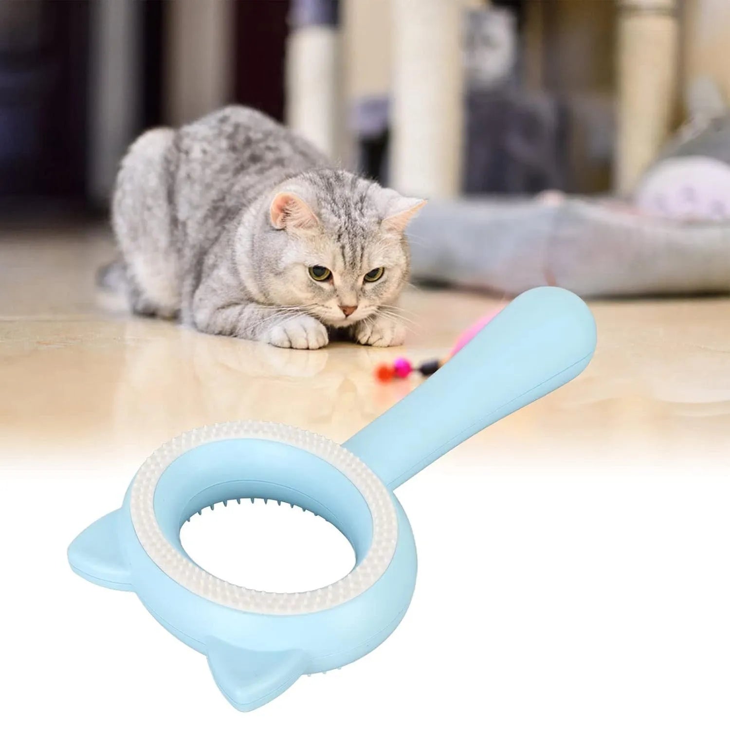 Blue and white double-sided pet grooming brush with ergonomic handle on a table