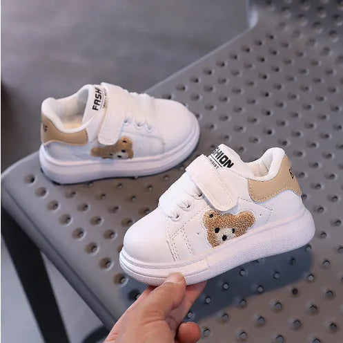 Baby Bear cartoon pattern children's sneakers in green, shown on a white background.