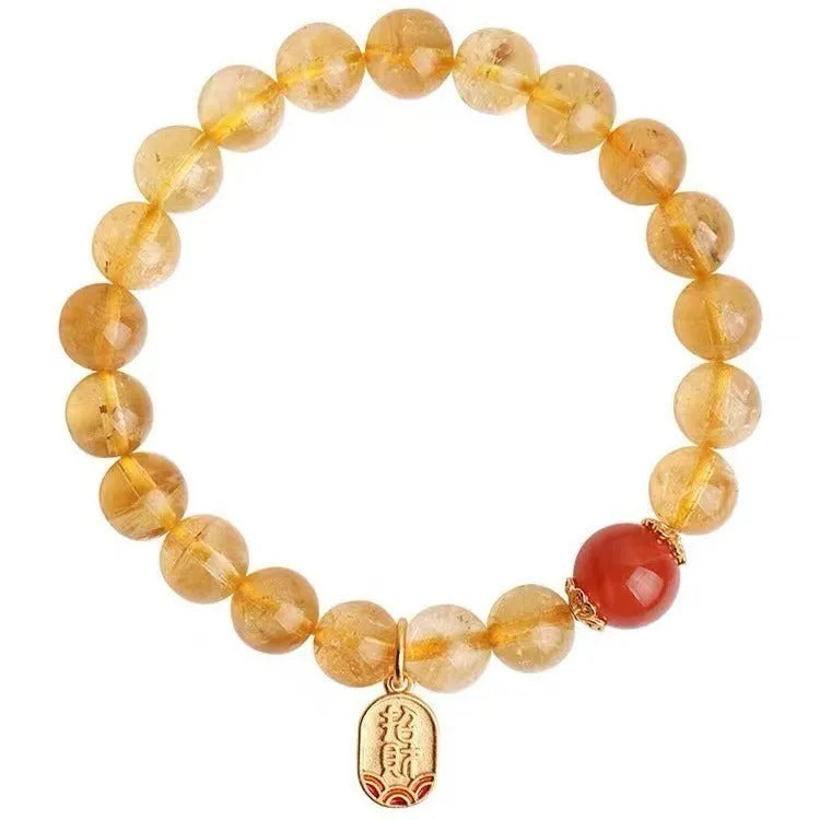Polished natural red agate lucky beads bracelet on a wrist, showing ruby colour beads.