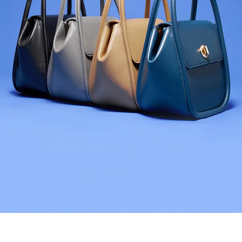 Women's leather wing shape tote bag with cross-body strap in four colour options showing buckle detail