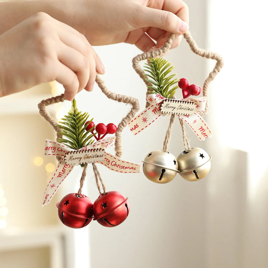 Iron Christmas bell ornament in gold hanging on a Christmas tree branch