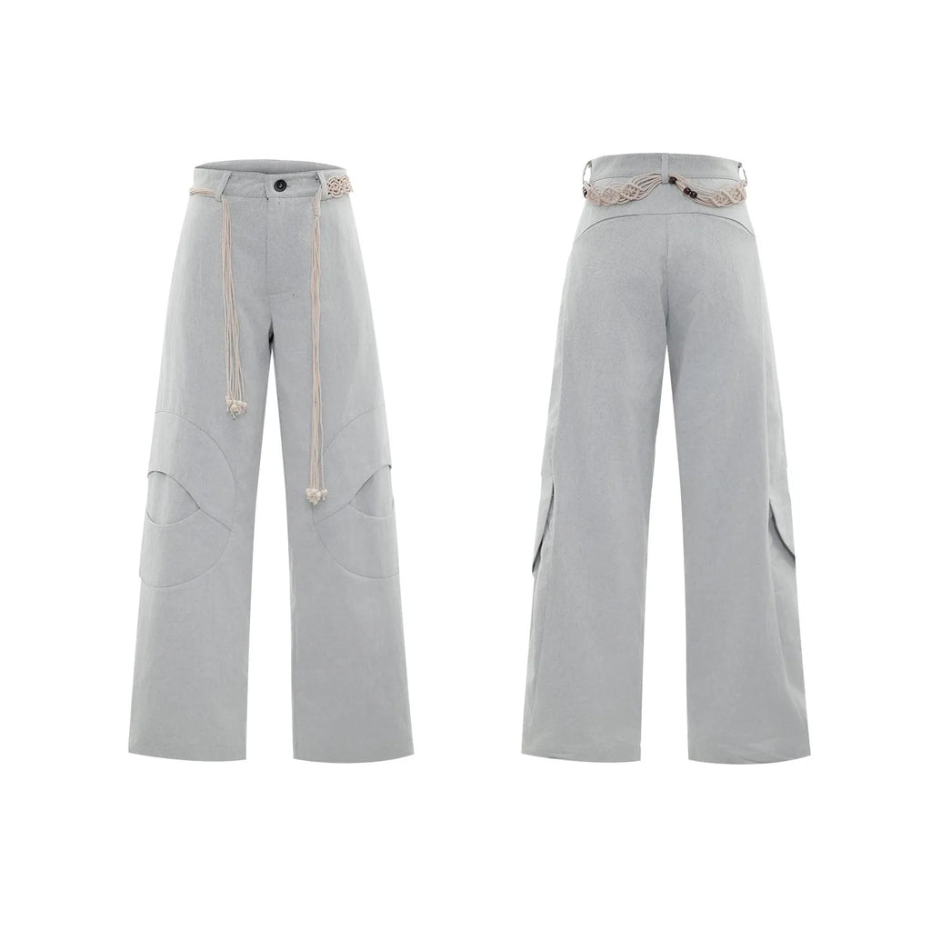 Man's dark blue straight-leg cotton trousers with belt stitching and zipper details on a loose fit.