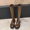 Women's black knee-high knight boots with a chunky heel, round toe, and back zipper.