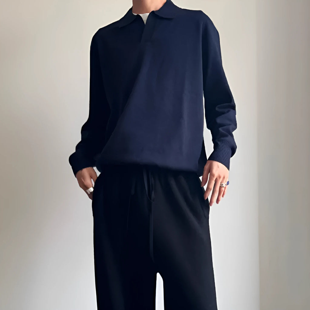 Pure wool polo sweater with a lapel collar in navy blue, shown in a loose fit on a model.