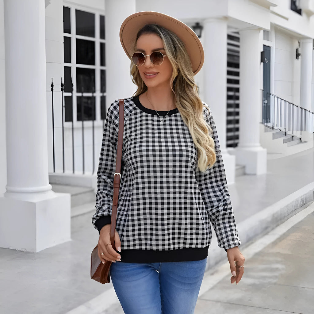 Black long sleeve polyester sweater with a plaid pattern, shown on a hanger.