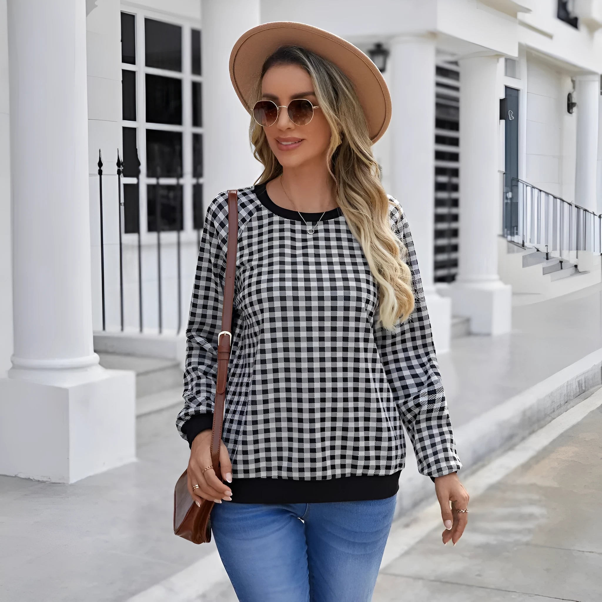 Black long sleeve polyester sweater with a plaid pattern, shown on a hanger.
