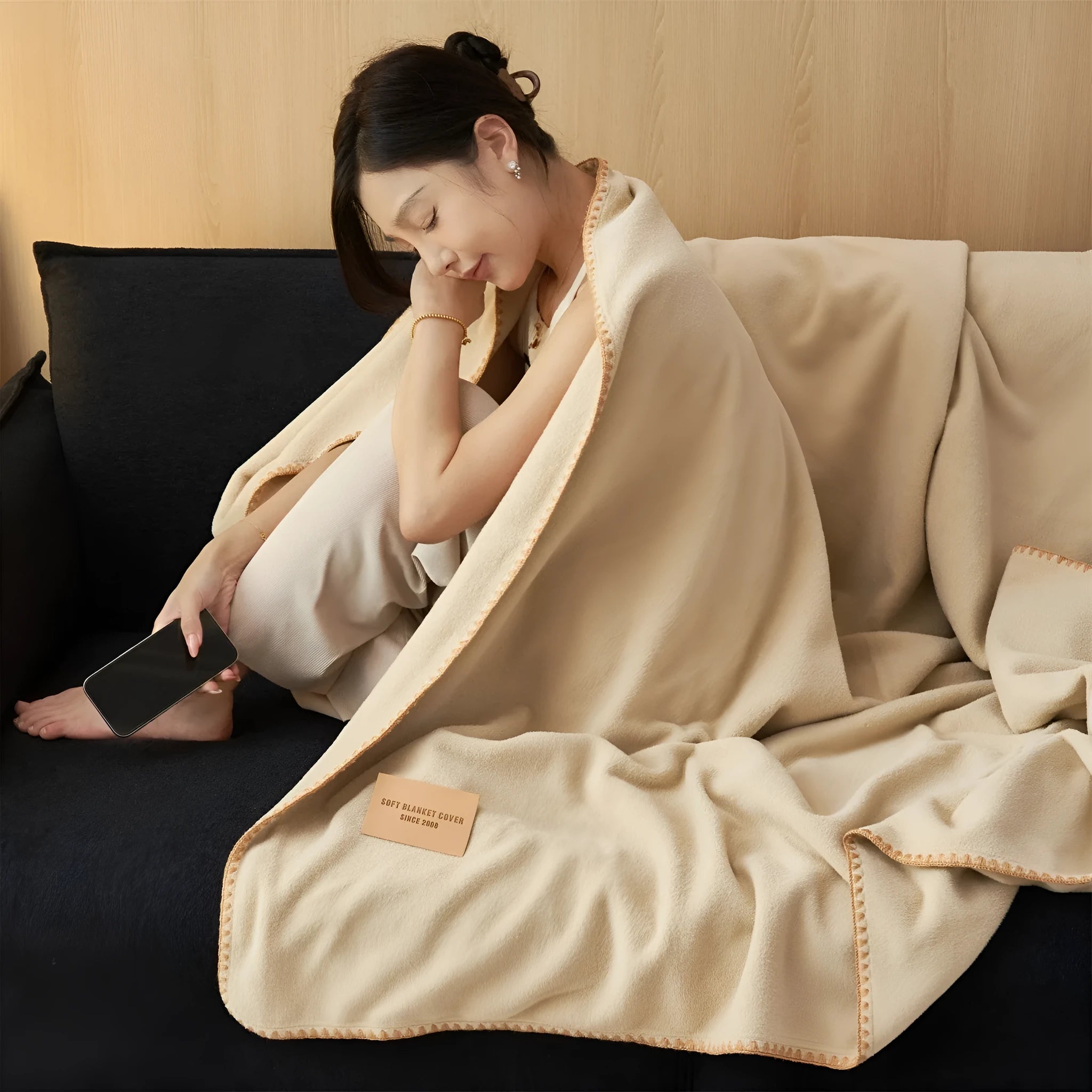 Class A Alpaca Fleecefiber blanket in solid colour, folded on a sofa, showing soft polyester texture