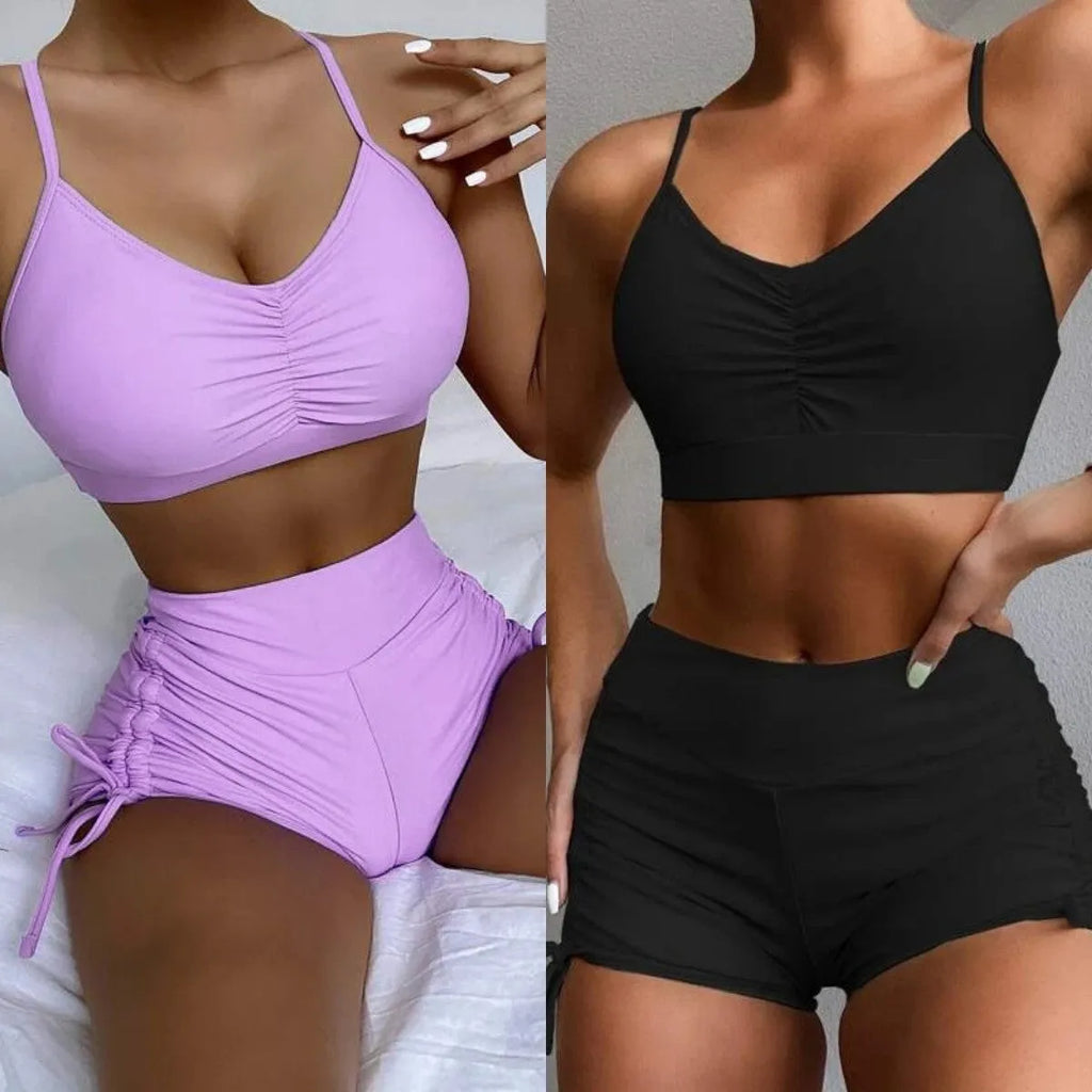 Women's black or purple high-waist split bikini swimsuit with sleeveless top and shorts.