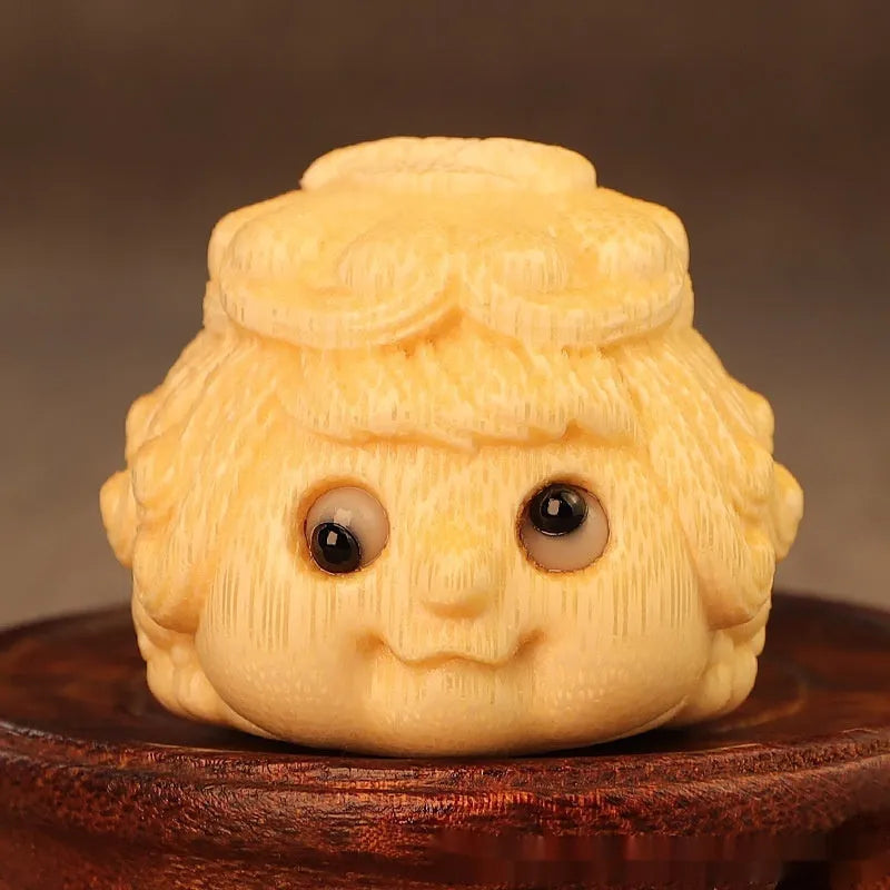 Solid bamboo carving of a cute golden toad princess ornament, 5 cm tall, on a plain background.