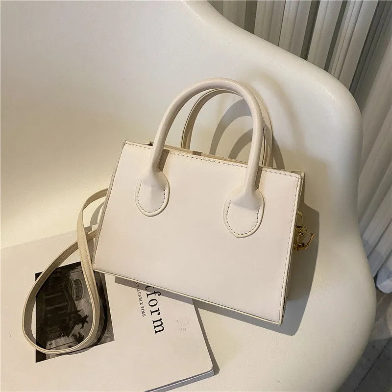 Women's black PU leather horizontal square shoulder bag with single strap and sewing line detailing