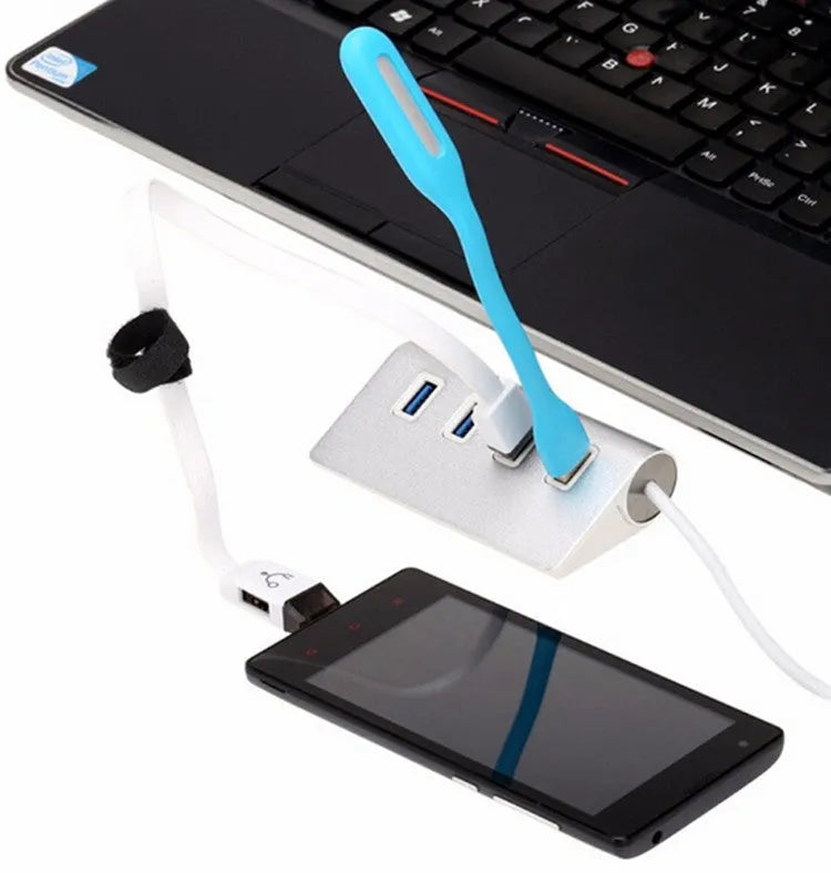 Silver aluminium alloy four-port USB 3.0 hub on a desk with cables connected, 98x58x30mm