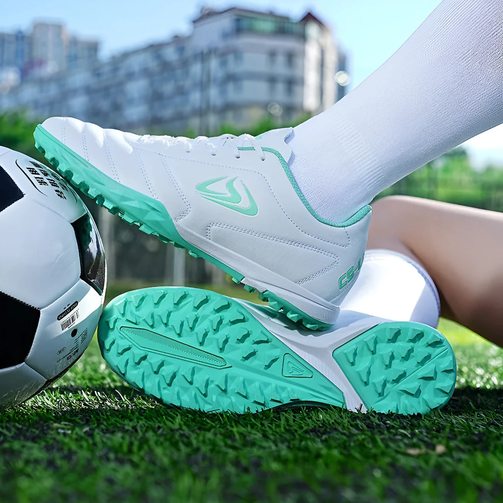 Men's outdoor football boots with synthetic leather upper and non-slip rubber sole for artificial grass