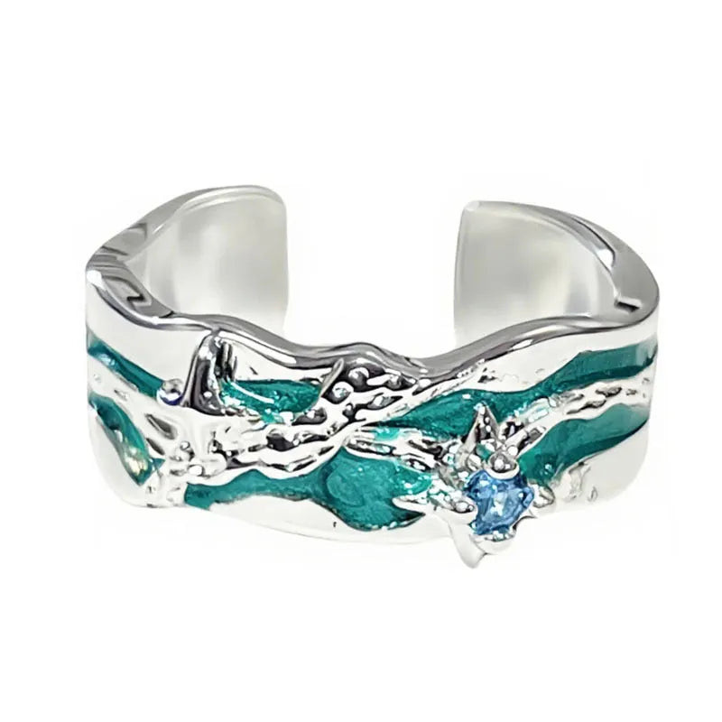 Mint green enamel ring with asymmetrical folded eight-point star design on copper band