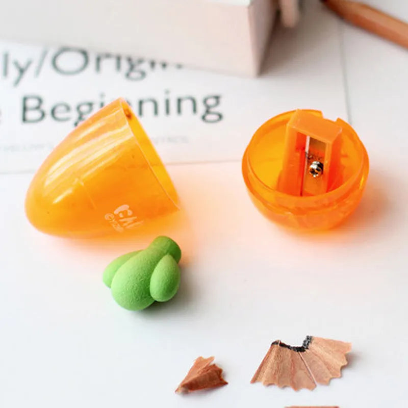 Carrot-shaped orange plastic pencil sharpener with green top, showing compact size next to pencil