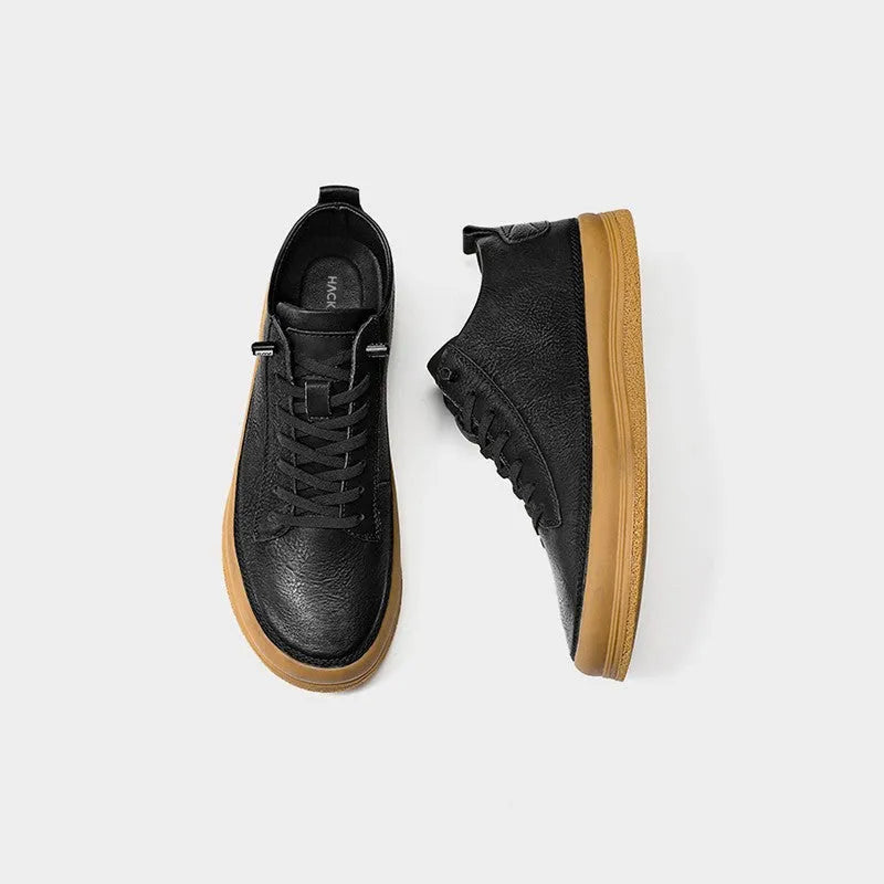Men's black and white casual leather shoes with round toe and flat rubber sole.