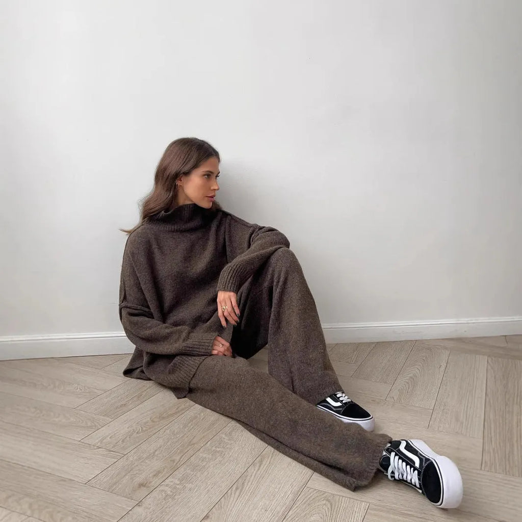 Women's dark grey casual suit with side-slit sweater top and matching trousers.