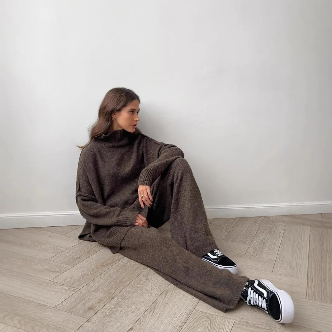 Women's dark grey casual suit with side-slit sweater top and matching trousers.