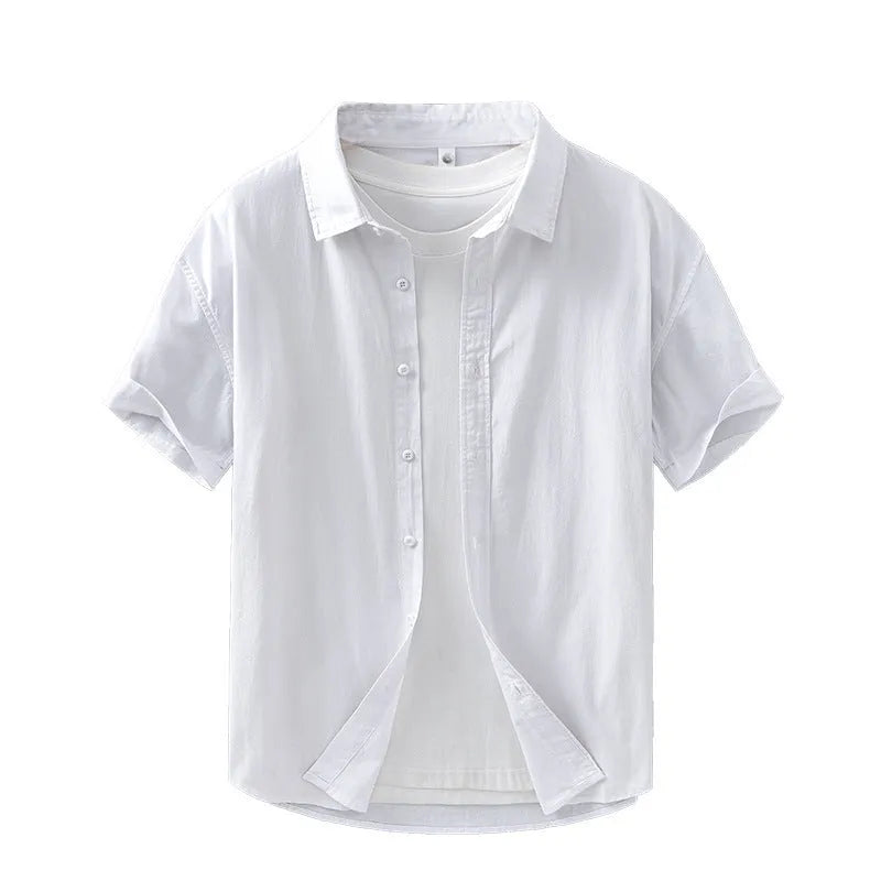 Man wearing a light grey loose-fitting short-sleeved cotton cardigan-style shirt.