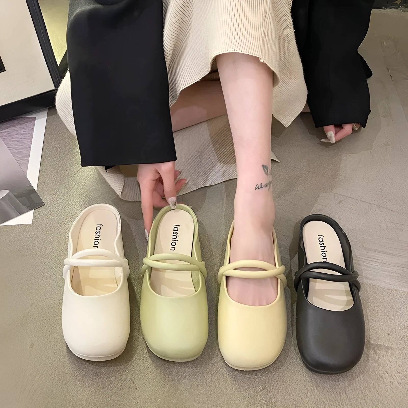 Women's black flip flop sandals with a toe cap design on a white background.