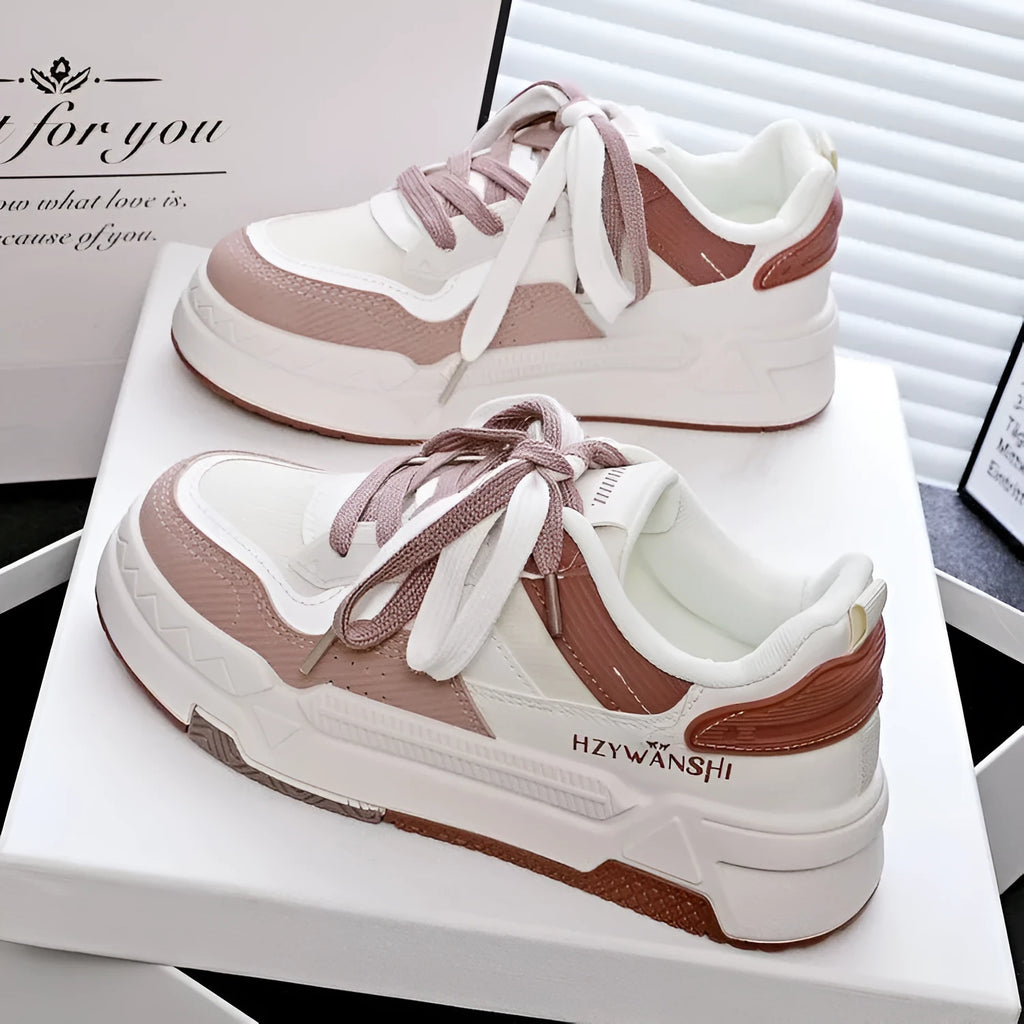 Children's beige board shoes with thick rubber soles, cross shoulder straps, and lace-up front.
