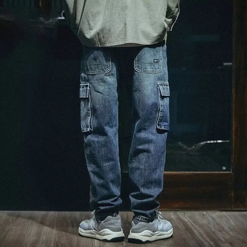 Man wearing blue loose straight-leg retro jeans with a zip fly, showcasing the casual fit.