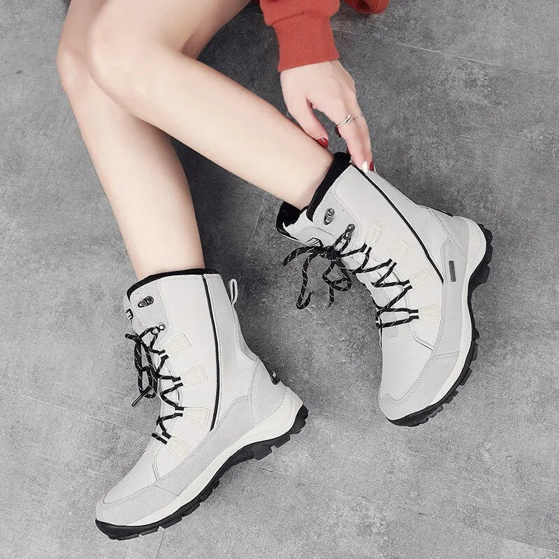 Women's black mid-calf snow boots with a round toe and genuine leather upper on a rubber sole.