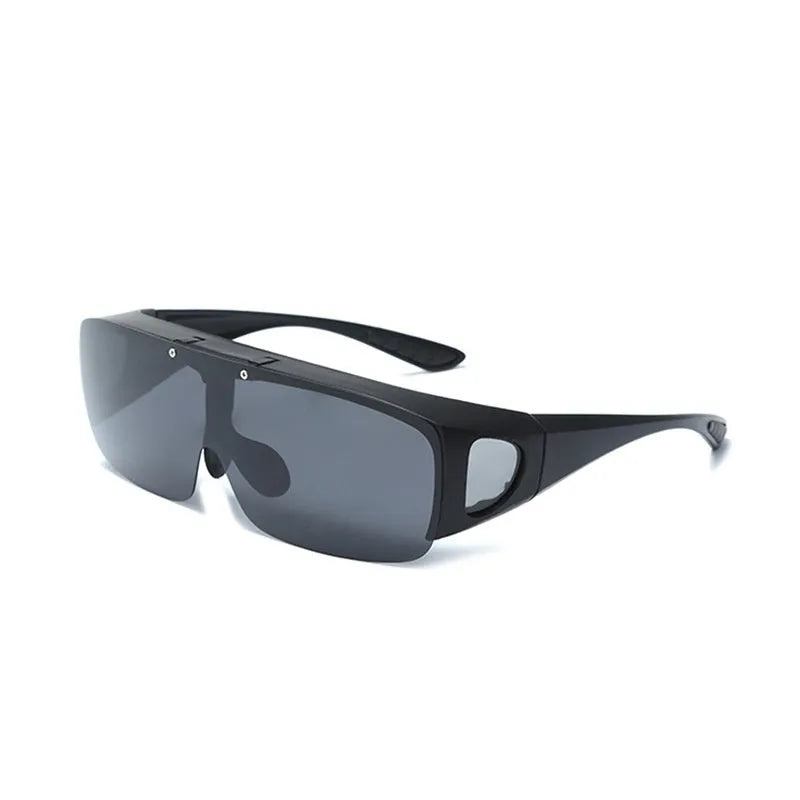 One-piece polarised sunglasses with myopia correction and multiple interchangeable coloured lens sheets laid out.