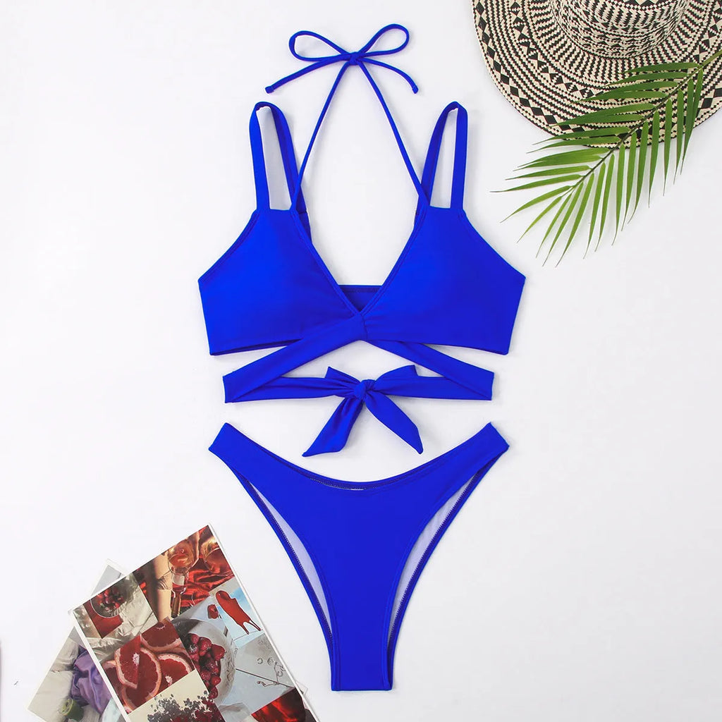 Women's solid colour strap bikini swimsuit on a hanger, shown in red.