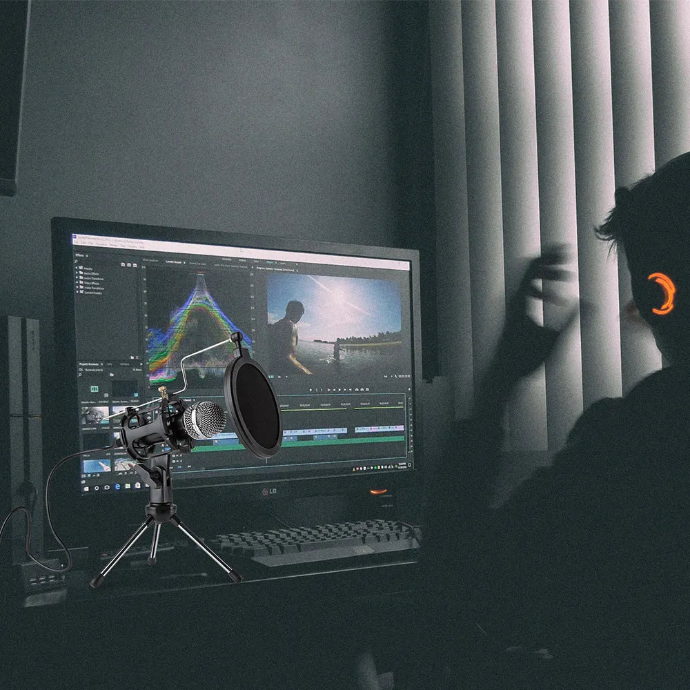 Black desktop omnidirectional microphone with metal mesh grille and 2m cable on a desk