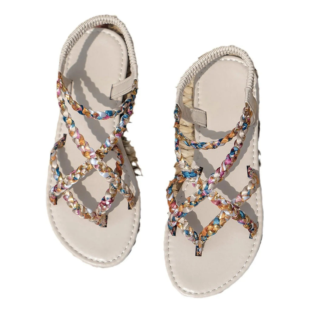 Women's white flat sandals with an elastic band fastening and a cloth upper.