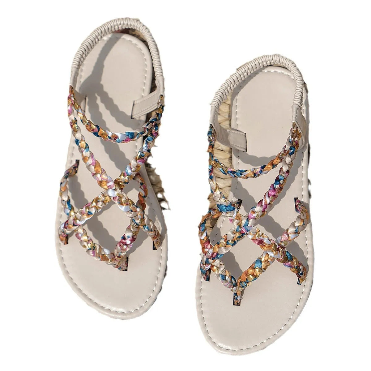 Women's white flat sandals with an elastic band fastening and a cloth upper.