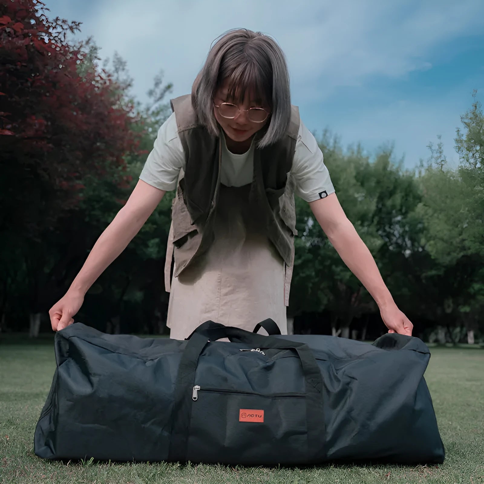 Blue waterproof storage bag for folding camping tables and chairs with compression straps