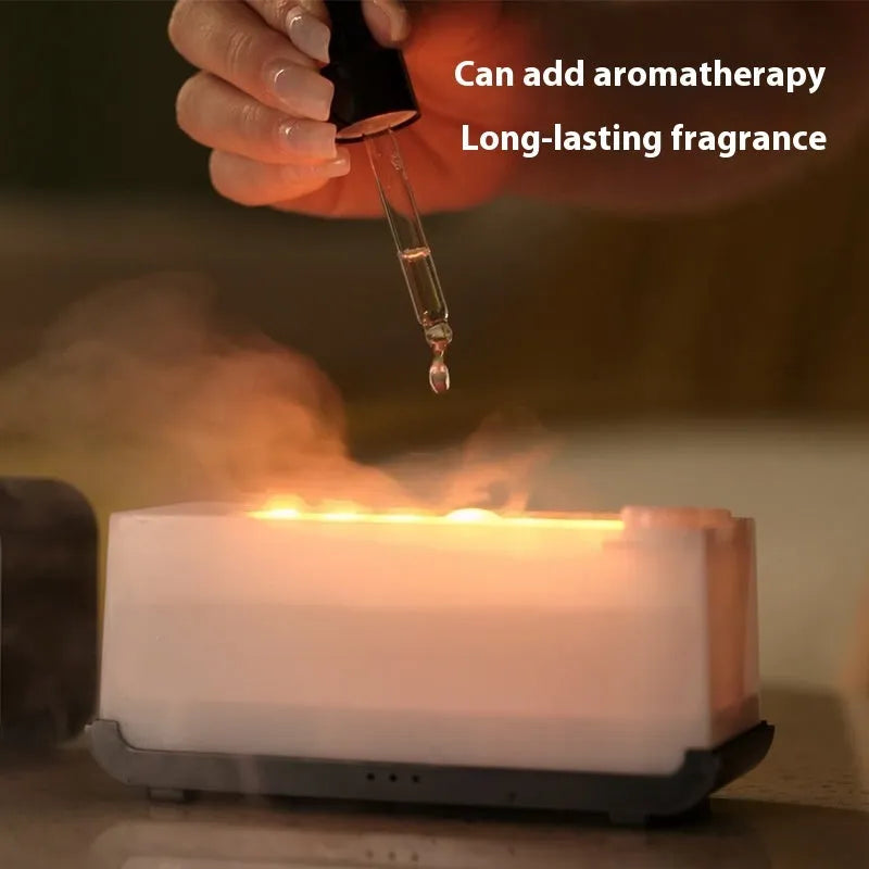 White USB aroma diffuser with simulated flame lighting effect on wooden surface