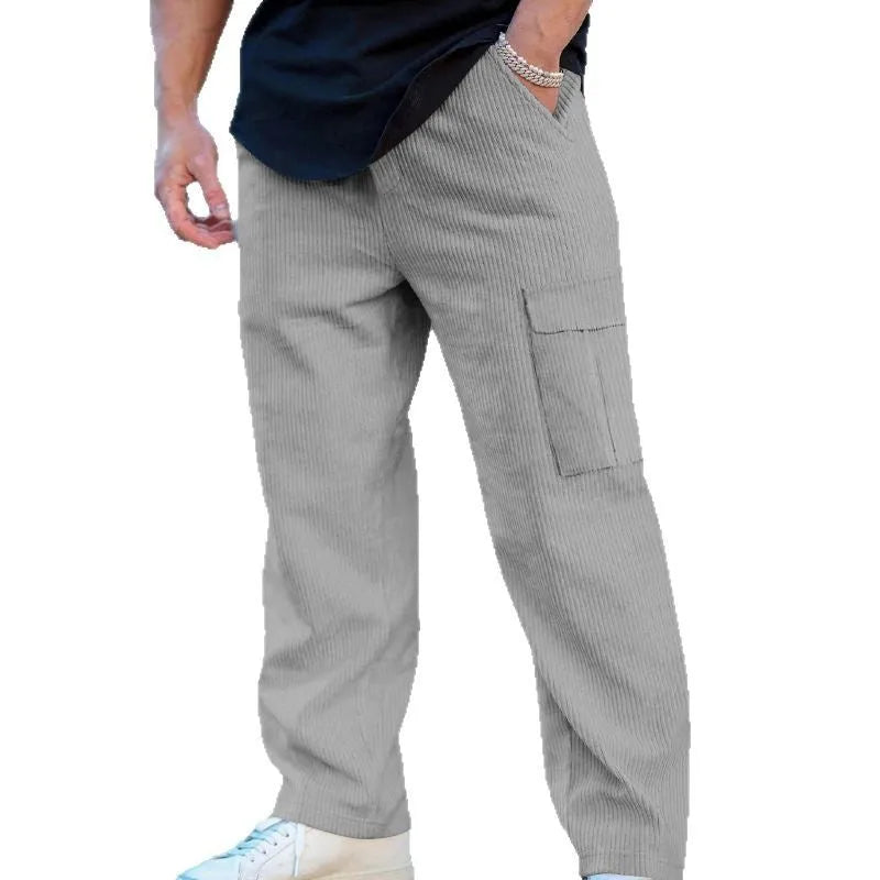 Men's navy blue corduroy wide-leg cargo trousers with a drawstring waist on a neutral background.
