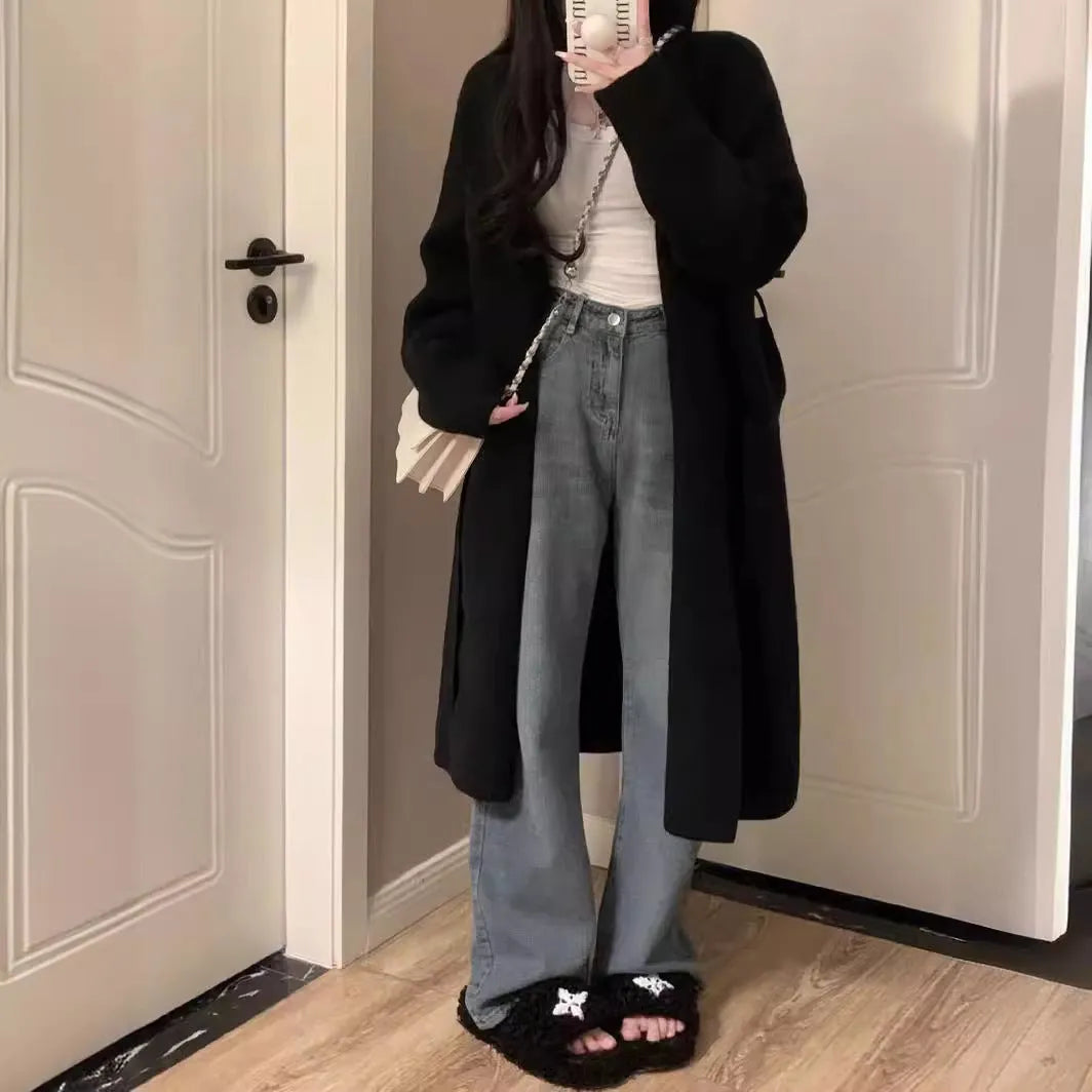 A woman's loose-fit knitted cardigan in a khaki colour with a V-neck and long sleeves, laid flat.
