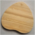 Square bamboo wood 5W wireless charger on a wooden surface.