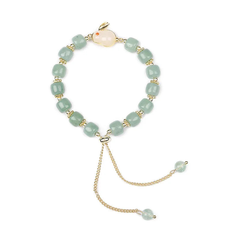 Women's rabbit design bracelet with green natural stones and copper gold accents