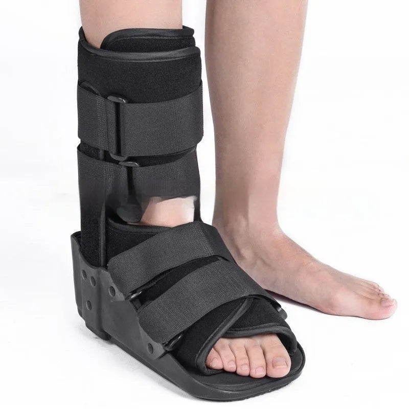 Grey and black Achilles tendon rehabilitation boot with adjustable straps and a rigid plastic shell
