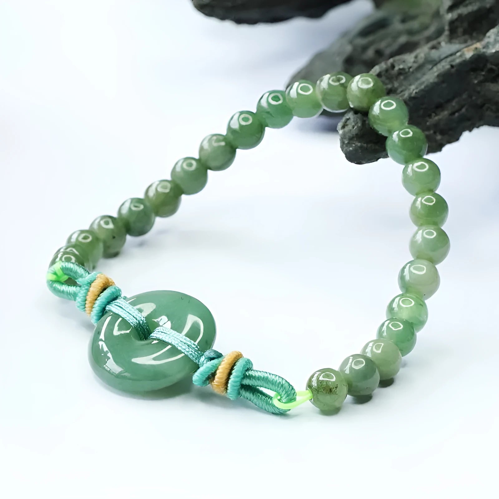 Natural emerald jade bracelet with star-shaped beads and a silver safety buckle.