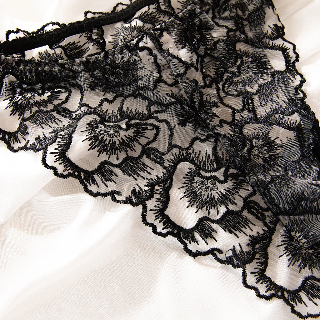 Black embroidered lace women's underwear with steel ring details on transparent mesh fabric