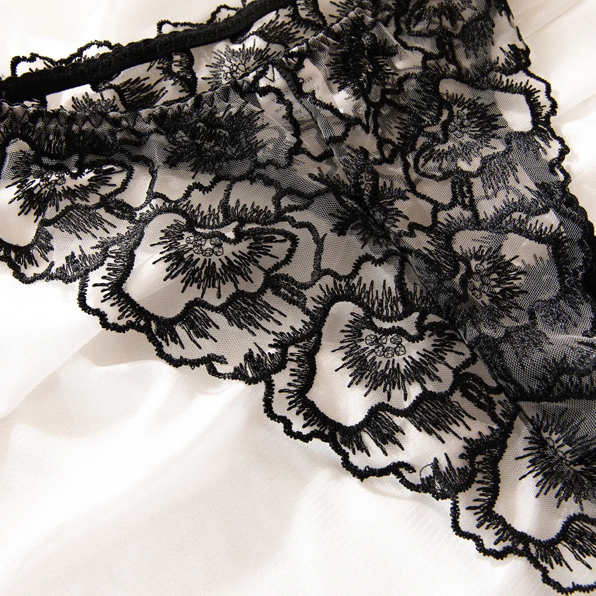 Black embroidered lace women's underwear with steel ring details on transparent mesh fabric