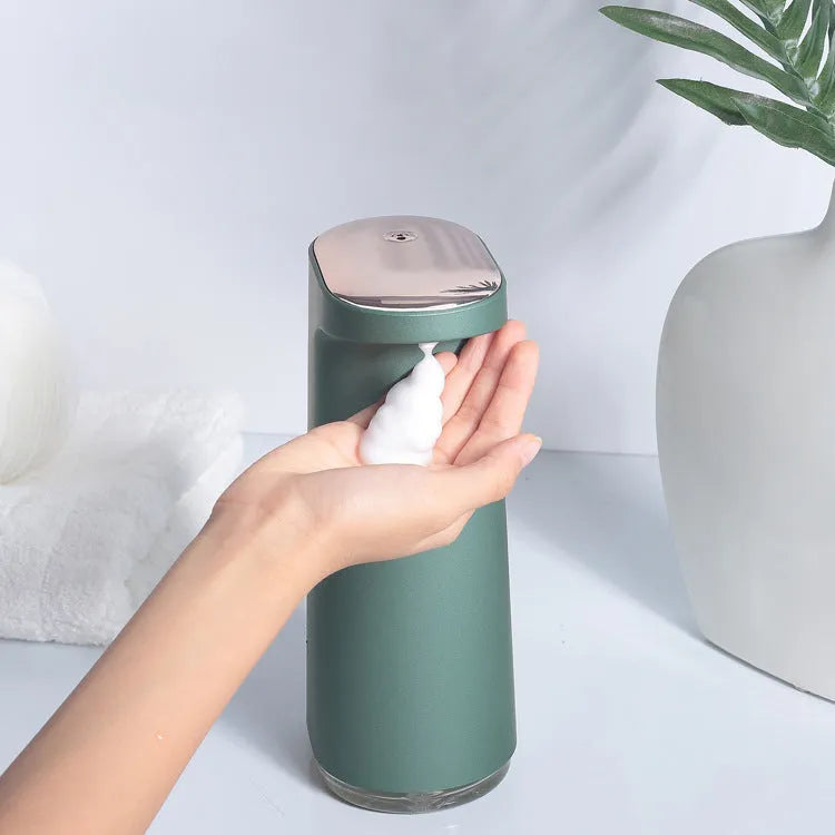 White automatic foam soap dispenser with sensor for touch-free operation on bathroom counter