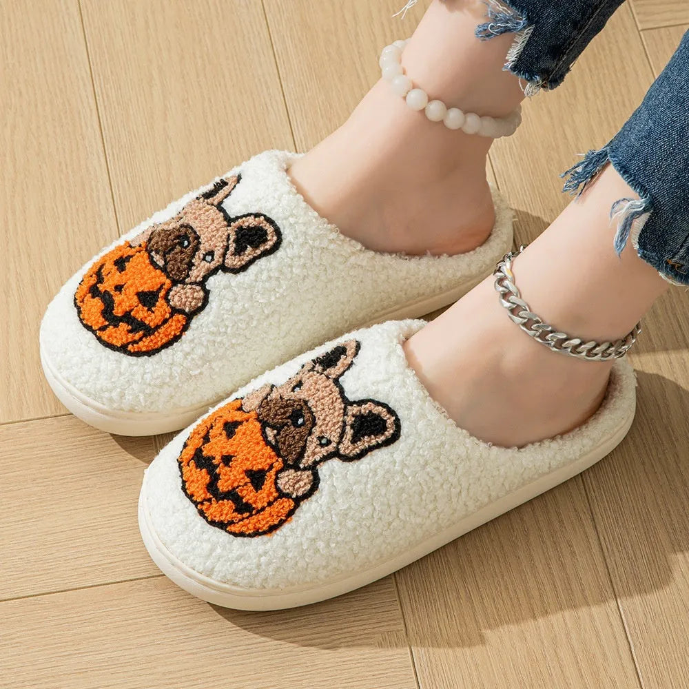 Black Halloween slippers with pumpkin design featuring soft plush upper and non-slip rubber soles.
