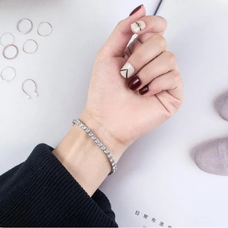 Women's simple diamond studded bracelet in gold finish with 4mm band width on white background
