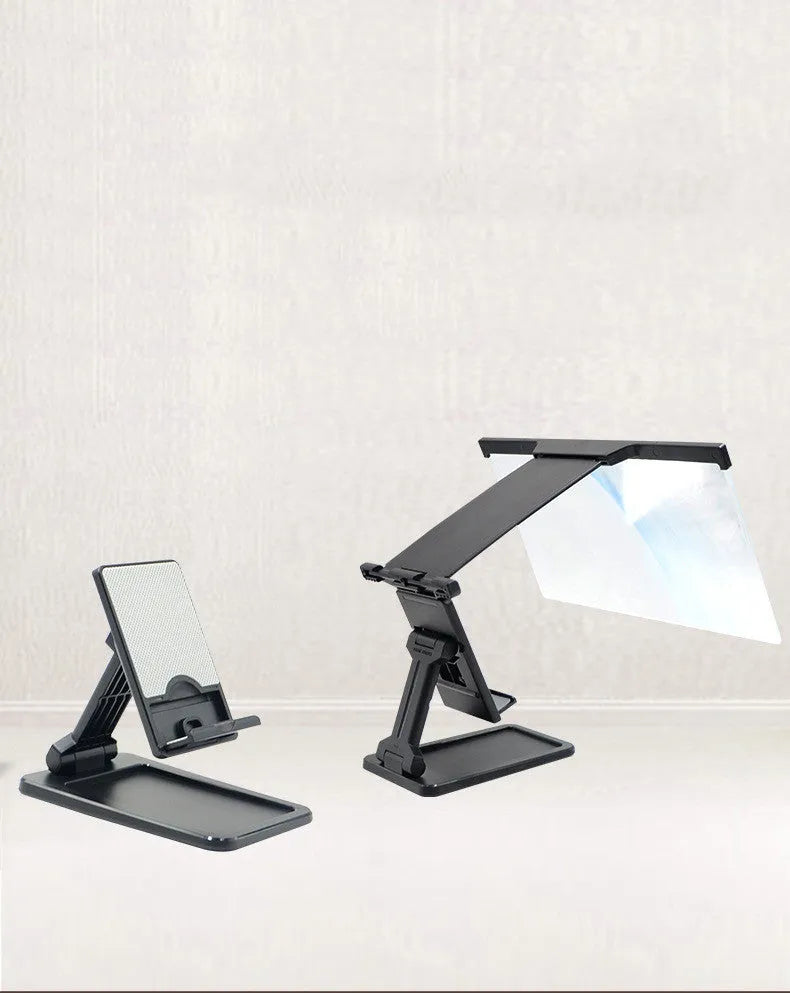 Black folding mobile phone screen amplifier with detached phone holder on a desk