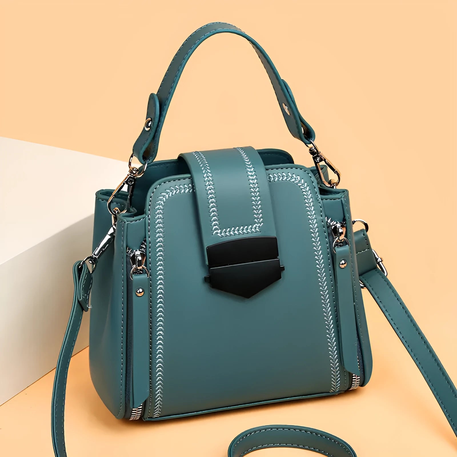 Small square vertical handbag in soft PU leather with textured stitching, shown in multiple colour options.