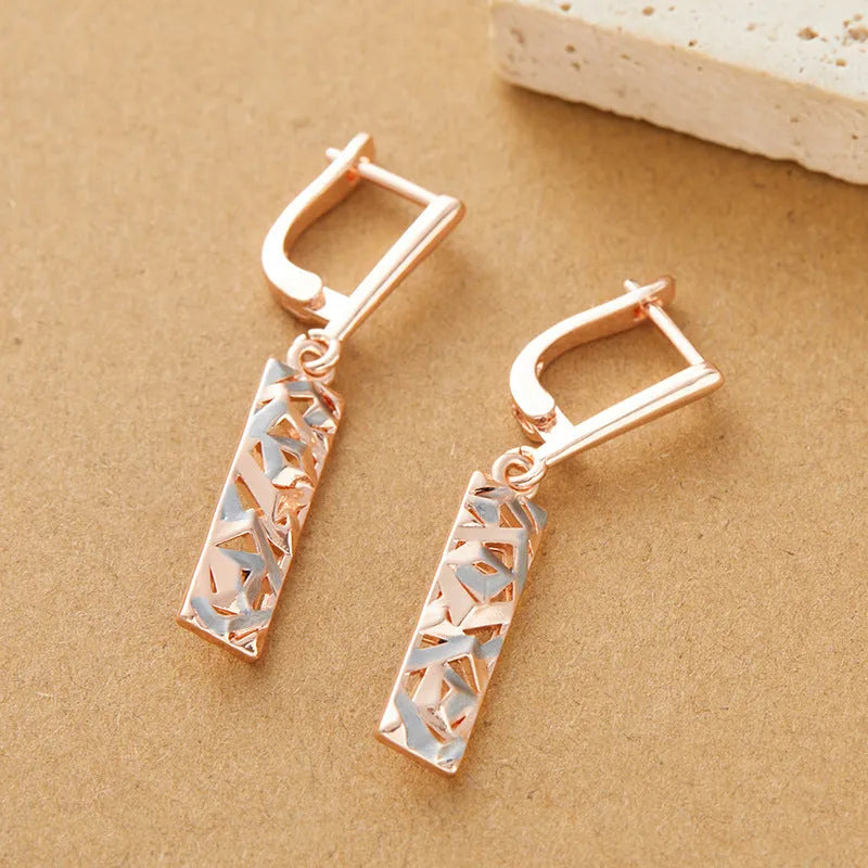 Rectangular two-tone hollow alloy stud earrings for women with electroplated finish.